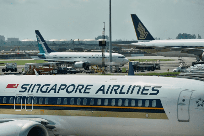 Passengers criticize SIA for poor support during long wait and lack of accommodations.