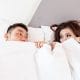 How to practise self care in a relationship - couple lying in bed